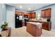 Spacious kitchen features black appliances, wood cabinets, tile floors, and kitchen island at 599 Jefferson Chase St, Atlanta, GA 30354