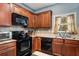 Kitchen area features stainless appliances, wood cabinets, granite countertops, and sink with window at 599 Jefferson Chase St, Atlanta, GA 30354