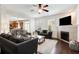 Open-concept living room features a decorative fireplace and seamless view to the eat-in kitchen at 599 Jefferson Chase St, Atlanta, GA 30354