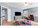 Spacious playroom with a TV, shelving and lots of toys, perfect for entertainment and activities at 599 Jefferson Chase St, Atlanta, GA 30354