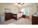 Comfortable carpeted bedroom with bed, dresser, and natural light from the window at 8220 Majors Ridge Way, Cumming, GA 30041