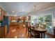 Spacious kitchen with wooden cabinets, granite countertops, stainless steel appliances, and an adjacent dining area at 8220 Majors Ridge Way, Cumming, GA 30041