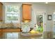 Granite topped kitchen island with sink and view to backyard at 8220 Majors Ridge Way, Cumming, GA 30041