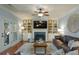 Cozy living room featuring a fireplace, built-in shelving, and hardwood floors at 8220 Majors Ridge Way, Cumming, GA 30041