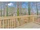 A newly constructed wooden deck overlooking a lush, wooded backyard provides a peaceful outdoor space at 125 Glenrose Sw Cir, Atlanta, GA 30354