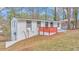 Charming renovated house with red railing on front porch and professionally landscaped yard at 125 Glenrose Sw Cir, Atlanta, GA 30354