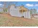 Exterior angle of the house featuring an elevated deck with the yard sloping away from the foundation at 125 Glenrose Sw Cir, Atlanta, GA 30354