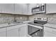 Kitchen features granite countertops, stainless steel appliances, and modern cabinets at 125 Glenrose Sw Cir, Atlanta, GA 30354