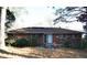 View of a brick home's backyard with a sliding door and sparse landscaping at 1879 Mural Cir, Morrow, GA 30260