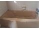 Standard bathtub with chrome fixtures, set against tile wall at 1879 Mural Cir, Morrow, GA 30260