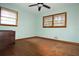 Bedroom featuring hardwood floors, light walls, and large windows at 1879 Mural Cir, Morrow, GA 30260