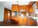 Kitchen featuring knotty pine cabinets, granite countertops, and stainless steel appliances at 1879 Mural Cir, Morrow, GA 30260