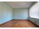 Living room with light blue walls, hardwood floors, and a bright window at 1879 Mural Cir, Morrow, GA 30260