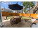 Backyard with patio set under umbrella, wooden fence, and green grass at 306 Nelms Ne Ave, Atlanta, GA 30307