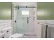 Modern bathroom featuring white subway tiles with black grout, glass shower door, and hexagon tile flooring at 306 Nelms Ne Ave, Atlanta, GA 30307