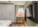 Well-lit bedroom with a mounted TV, custom wardrobe, and a cozy workspace at 306 Nelms Ne Ave, Atlanta, GA 30307