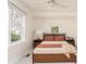 Bright bedroom with white walls, large windows, neutral tones, and simple furniture at 306 Nelms Ne Ave, Atlanta, GA 30307