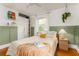 Well-lit bedroom with green accent, built in wardrobe and shelves, natural light and hardwood floors at 306 Nelms Ne Ave, Atlanta, GA 30307