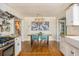 Bright dining area featuring hardwood floors, stylish art, and modern light fixture off the kitchen at 306 Nelms Ne Ave, Atlanta, GA 30307