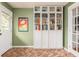 Stylish mudroom with herringbone brick floors, bookcase, and doorway to the outside at 306 Nelms Ne Ave, Atlanta, GA 30307