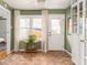 Welcoming entryway featuring herringbone brick floors, natural light, and a stylish bookcase at 306 Nelms Ne Ave, Atlanta, GA 30307