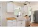 Bright kitchen with stainless steel dishwasher, farmhouse sink, and wooden countertops at 306 Nelms Ne Ave, Atlanta, GA 30307