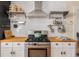 Modern kitchen featuring butcher block countertops, stainless steel oven, and white cabinets at 306 Nelms Ne Ave, Atlanta, GA 30307