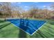 Full-size tennis court on a partially cloudy day for recreation and exercise, with a fenced border and playground at 306 Nelms Ne Ave, Atlanta, GA 30307