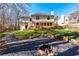 An inviting backyard with a wooden deck and a stone fire pit for cozy outdoor gatherings at 565 Ashvale Overlook, Alpharetta, GA 30005