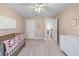 Comfortable Bedroom with neutral paint, showcasing a crib, changing table, and hallway access at 565 Ashvale Overlook, Alpharetta, GA 30005