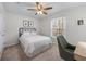 Well-lit bedroom with a cozy bed, neutral colors, and a stylish desk area by the window at 565 Ashvale Overlook, Alpharetta, GA 30005