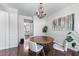 Elegant dining room featuring a chandelier, hardwood floors, and modern decor at 565 Ashvale Overlook, Alpharetta, GA 30005