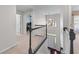 Hallway view from staircase showing open floorplan and natural light at 565 Ashvale Overlook, Alpharetta, GA 30005