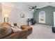 Comfortable living room with a ceiling fan and a large window providing natural light at 565 Ashvale Overlook, Alpharetta, GA 30005