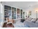 Bright living room with a decorative rug, and built in shelving unit painted gray and white with decorations at 565 Ashvale Overlook, Alpharetta, GA 30005