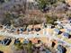 An aerial view of a residential neighborhood highlighting a home with a spacious backyard, deck, and landscaping at 6951 Foxmoor Way, Douglasville, GA 30134