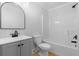 Bathroom has a gray vanity with a framed mirror, toilet, and shower/tub combination with white walls at 6951 Foxmoor Way, Douglasville, GA 30134