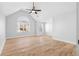 Bedroom has a vaulted ceiling, wood-look floors, a ceiling fan, and a window at 6951 Foxmoor Way, Douglasville, GA 30134