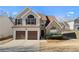 Charming two-story home featuring a two-car garage, stone accents and well-manicured landscaping at 6951 Foxmoor Way, Douglasville, GA 30134