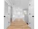 Hallway features wood-look flooring, staircase with white railing, and white doors at 6951 Foxmoor Way, Douglasville, GA 30134