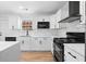 Modern kitchen with white cabinets, marble countertops, and stainless steel appliances at 6951 Foxmoor Way, Douglasville, GA 30134