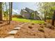 Large, landscaped backyard with a stone walkway leading to the upper level of the home at 783 Phil Haven Ln, Kennesaw, GA 30152