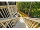 Stairway leading to a landscaped backyard with a view of lush greenery and a lake at 783 Phil Haven Ln, Kennesaw, GA 30152