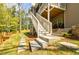 Backyard with staircase leading up to a patio, landscaping, and fencing at 783 Phil Haven Ln, Kennesaw, GA 30152