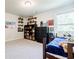 Comfortable bedroom featuring carpet flooring, custom shelving, and a cozy daybed at 783 Phil Haven Ln, Kennesaw, GA 30152