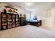 Inviting bedroom featuring carpet flooring, custom shelving, and a cozy daybed at 783 Phil Haven Ln, Kennesaw, GA 30152