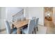 Elegant dining room featuring a wooden table, gray upholstered chairs, and staircase at 783 Phil Haven Ln, Kennesaw, GA 30152