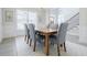 Elegant dining room with stylish seating, hardwood floors, and natural light from a large window at 783 Phil Haven Ln, Kennesaw, GA 30152