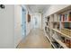 Hallway with white walls, wood floors, and built-in bookshelves at 783 Phil Haven Ln, Kennesaw, GA 30152