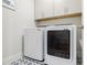 Bright laundry room featuring a front load washer and dryer with tile flooring at 783 Phil Haven Ln, Kennesaw, GA 30152